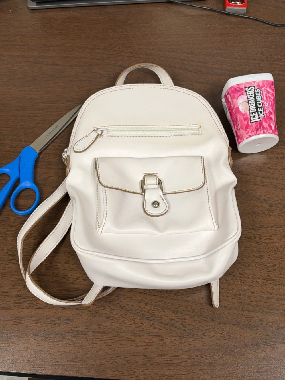 Nine West white small backpack with zippered and snap pockets on exterior